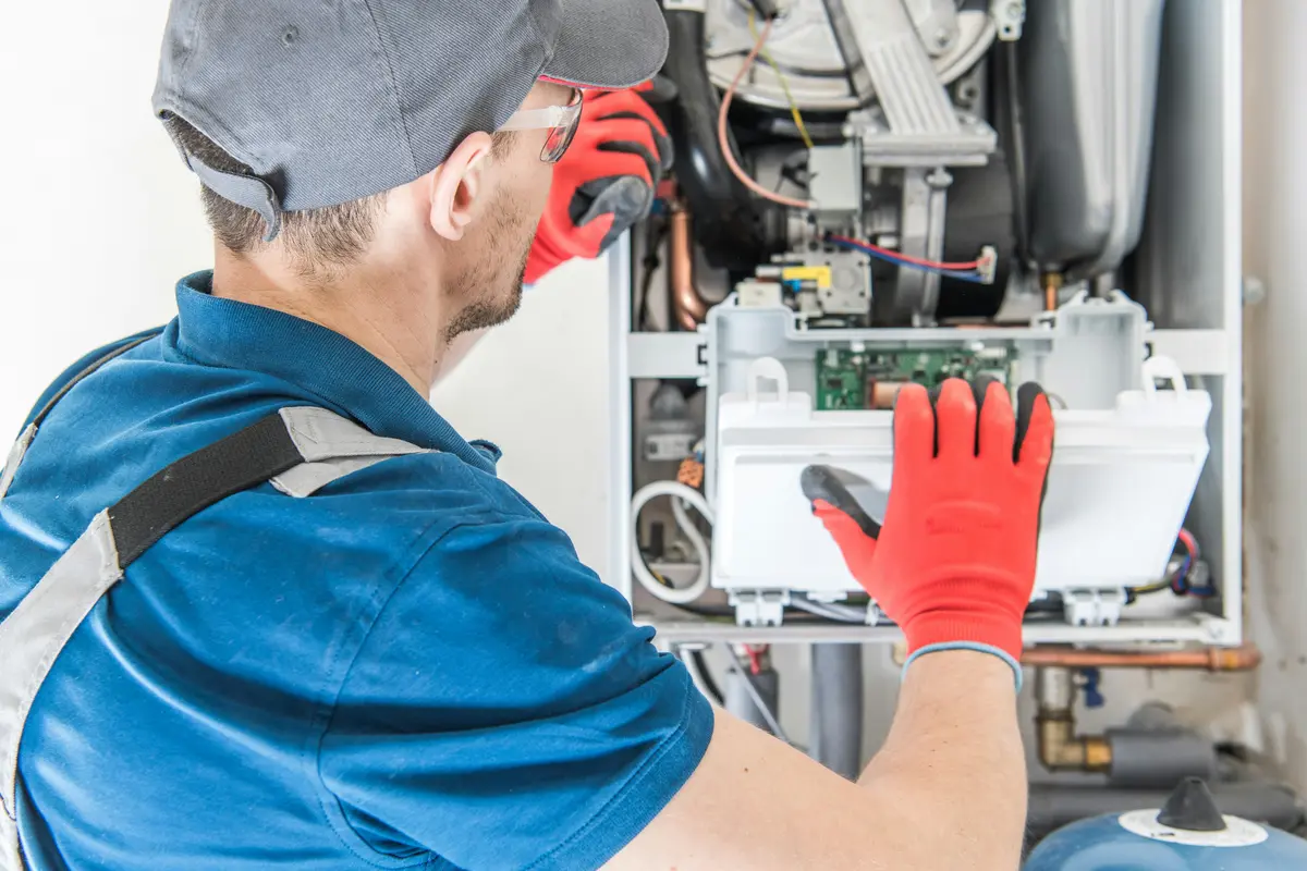 HVAC technician performing annual maintenance on a boiler in Toronto