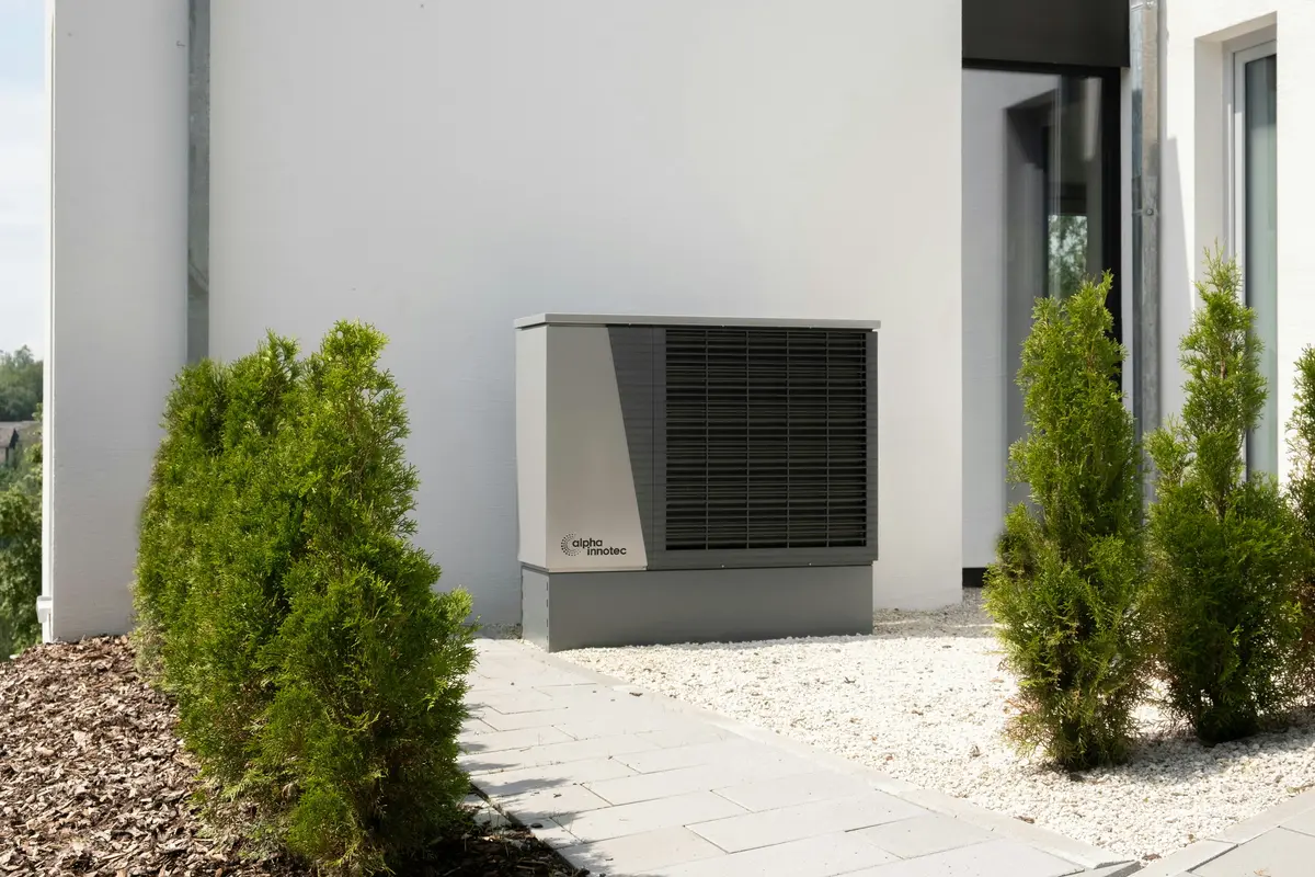 Cold-climate heat pump outdoor unit mounted on Toronto home exterior